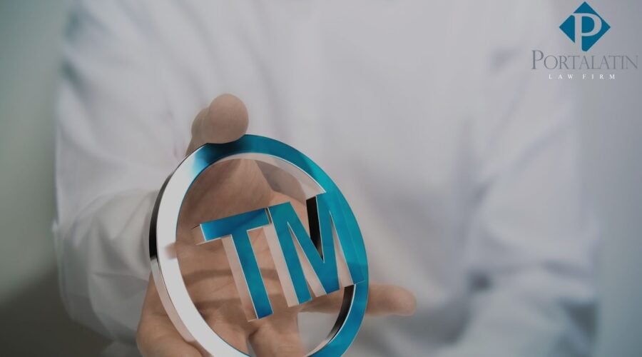 Person holding TM symbol, Portalatin Law Firm logo