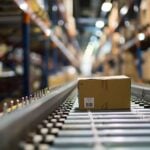 Cardboard box on conveyor belt in warehouse