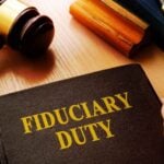 Fiduciary Duty book with gavel on table