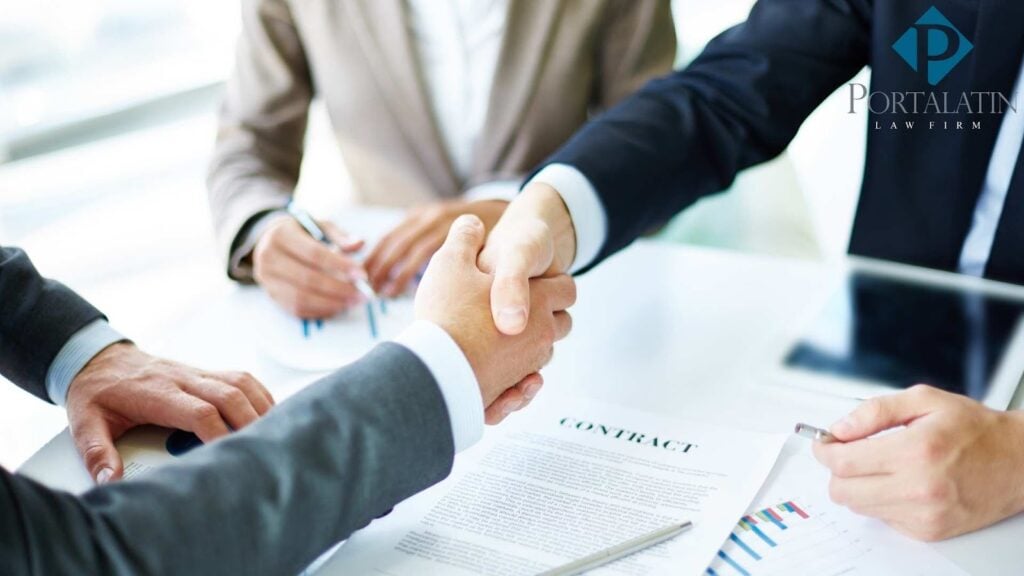 Business handshake over contract at law firm