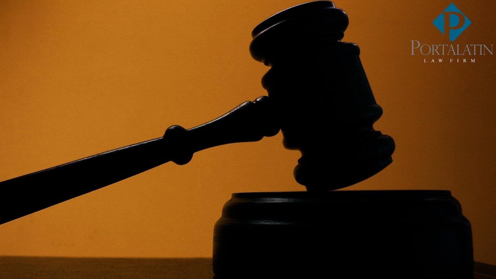 Judge's gavel silhouette on orange background