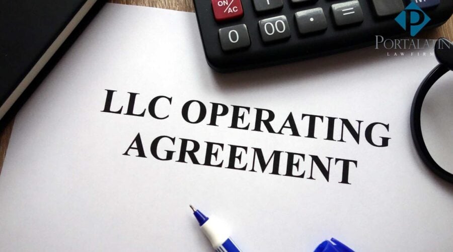 LLC Operating Agreement document with calculator and pen