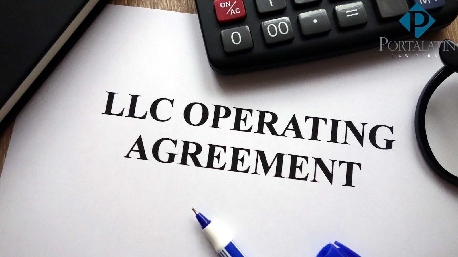 LLC Operating Agreement document with calculator and pen