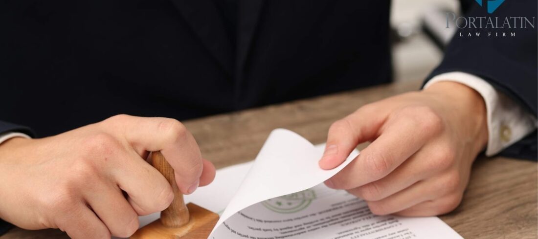 Lawyer stamping legal document at desk.