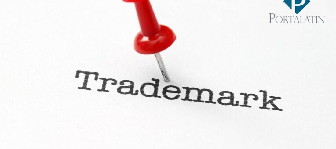 Trademark with red pushpin on paper