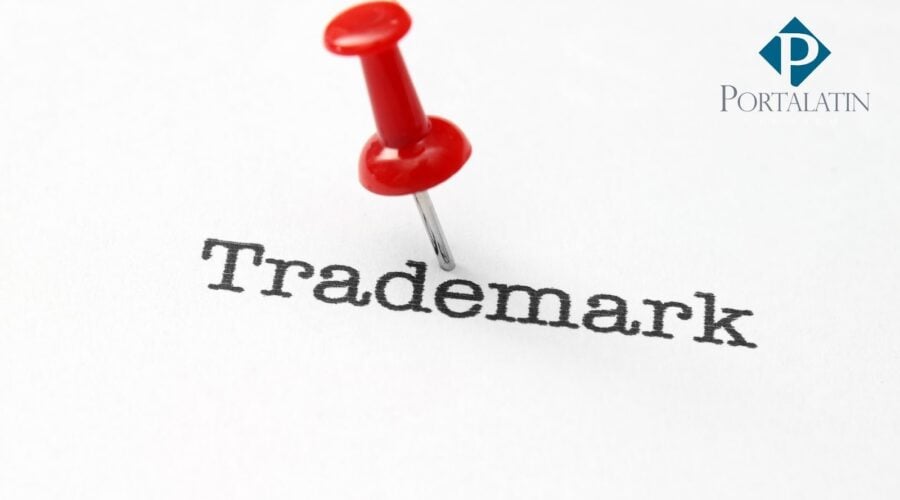 Trademark with red pushpin on paper