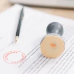 Approved legal document with pen and stamp