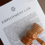 judge gavel laying on employment law documents