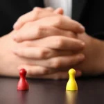Lawyer behind red and yellow game pieces