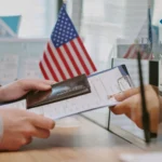 Portalatin (9) Person submitting passport and documents at office counter for E-2 Visa application