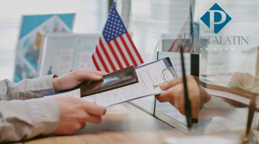 Person submitting passport and documents at office counter for E-2 Visa application